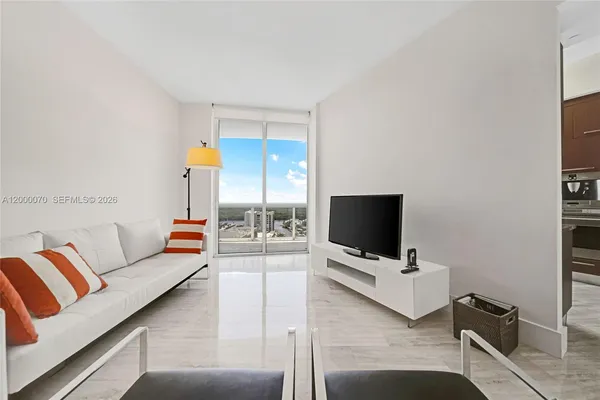 a living room with furniture and a flat screen tv