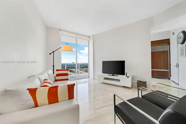 a living room with furniture and a flat screen tv