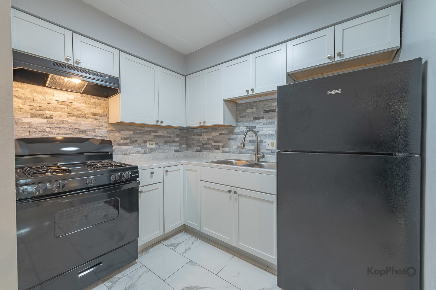 669 Chappel Avenue, Unit 1A Calumet City, IL 60409 - Photo 11 of 24 a kitchen with cabinets appliances and a window