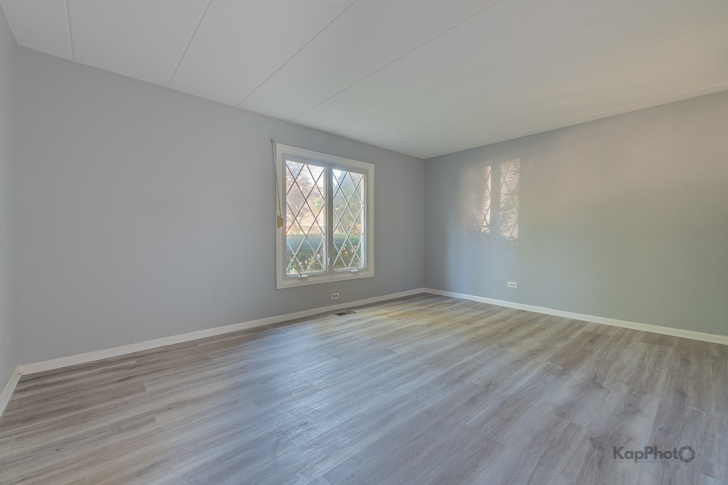 669 Chappel Avenue, Unit 1A Calumet City, IL 60409 - Photo 13 of 24 an empty room with wooden floor and windows