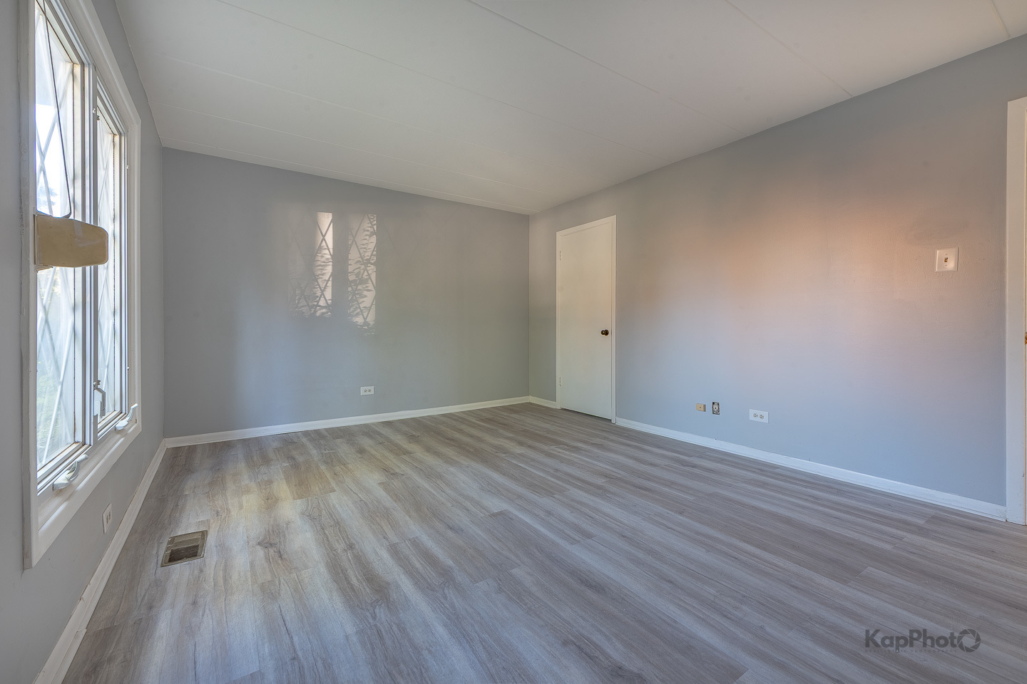 669 Chappel Avenue, Unit 1A Calumet City, IL 60409 - Photo 15 of 24 an empty room with wooden floor and windows