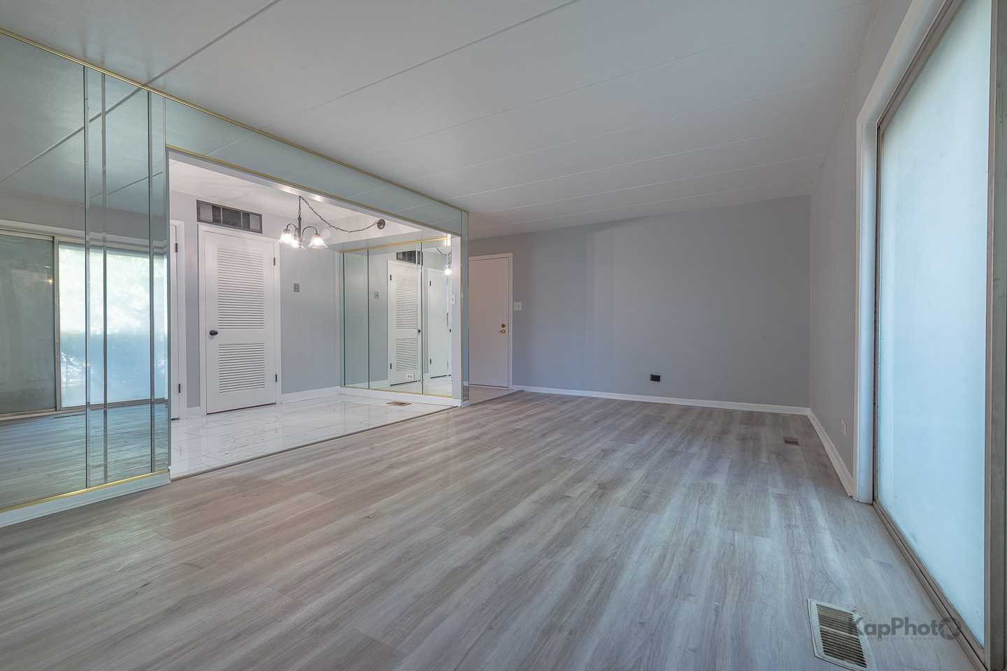 669 Chappel Avenue, Unit 1A Calumet City, IL 60409 - Photo 4 of 24 a view of an empty room with wooden floor and a window