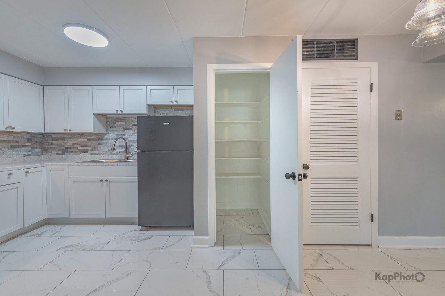669 Chappel Avenue, Unit 1A Calumet City, IL 60409 - Photo 6 of 24 a kitchen with a refrigerator and cabinets