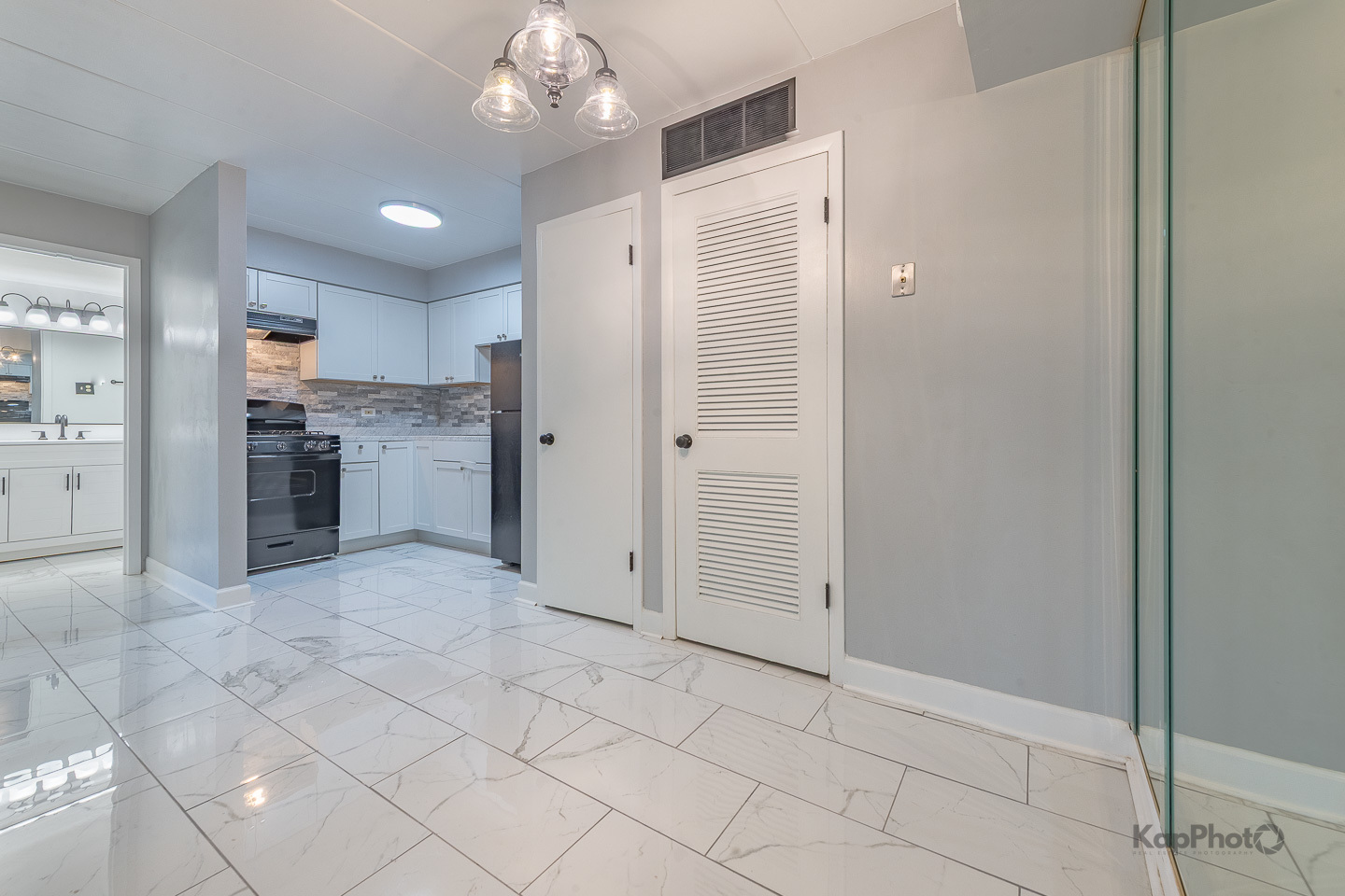 669 Chappel Avenue, Unit 1A Calumet City, IL 60409 - Photo 7 of 24 an empty room with kitchen view and wooden floor