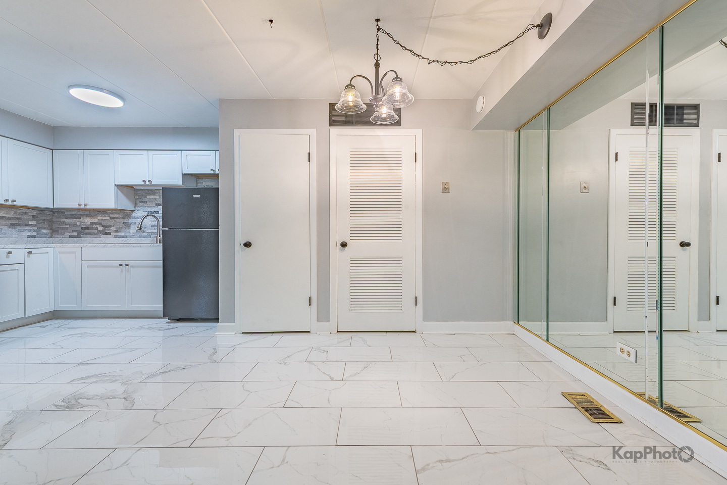 669 Chappel Avenue, Unit 1A Calumet City, IL 60409 - Photo 8 of 24 a view of a bathroom with a granite countertop shower a sink and a mirror