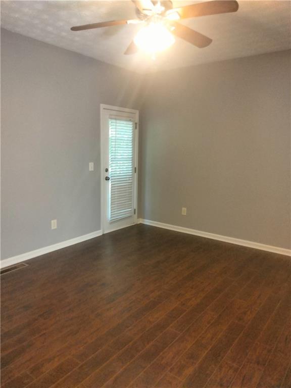 3299 Hampton Green Way Atlanta, GA 30340 - Photo 11 of 22 a view of an empty room with wooden floor and a window