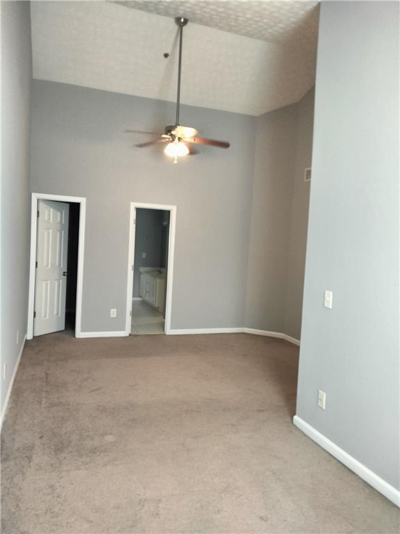 3299 Hampton Green Way Atlanta, GA 30340 - Photo 13 of 22 an empty room with chandelier fan and windows