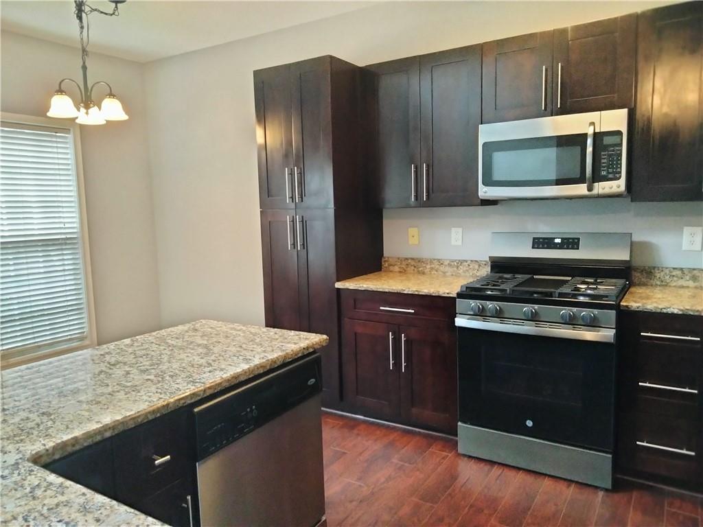3299 Hampton Green Way Atlanta, GA 30340 - Photo 7 of 22 a kitchen with stainless steel appliances granite countertop a stove a refrigerator and a microwave
