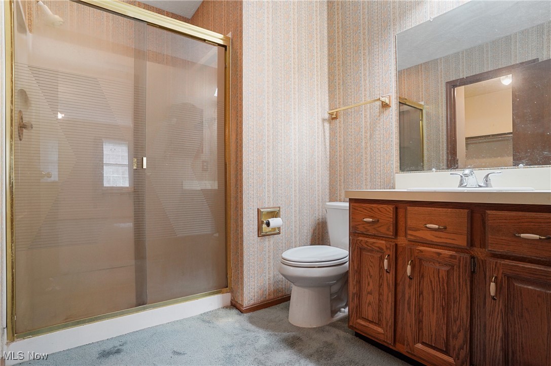 7300 Morley Road Painesville, OH 44077 - Photo 30 of 50 Bathroom with wallpapered walls, a stall shower, and vanity