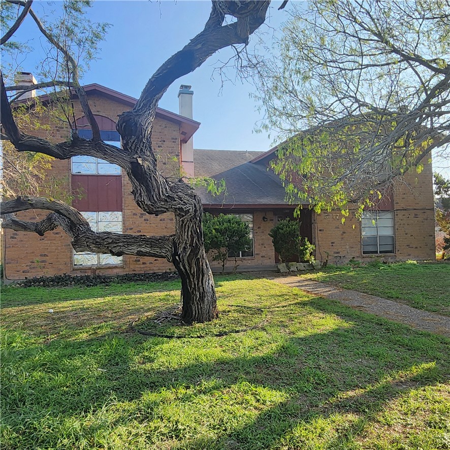 5077 Wingfoot Lane Corpus Christi, TX 78413 - Photo 1 of 4 a front view of a house with a garden