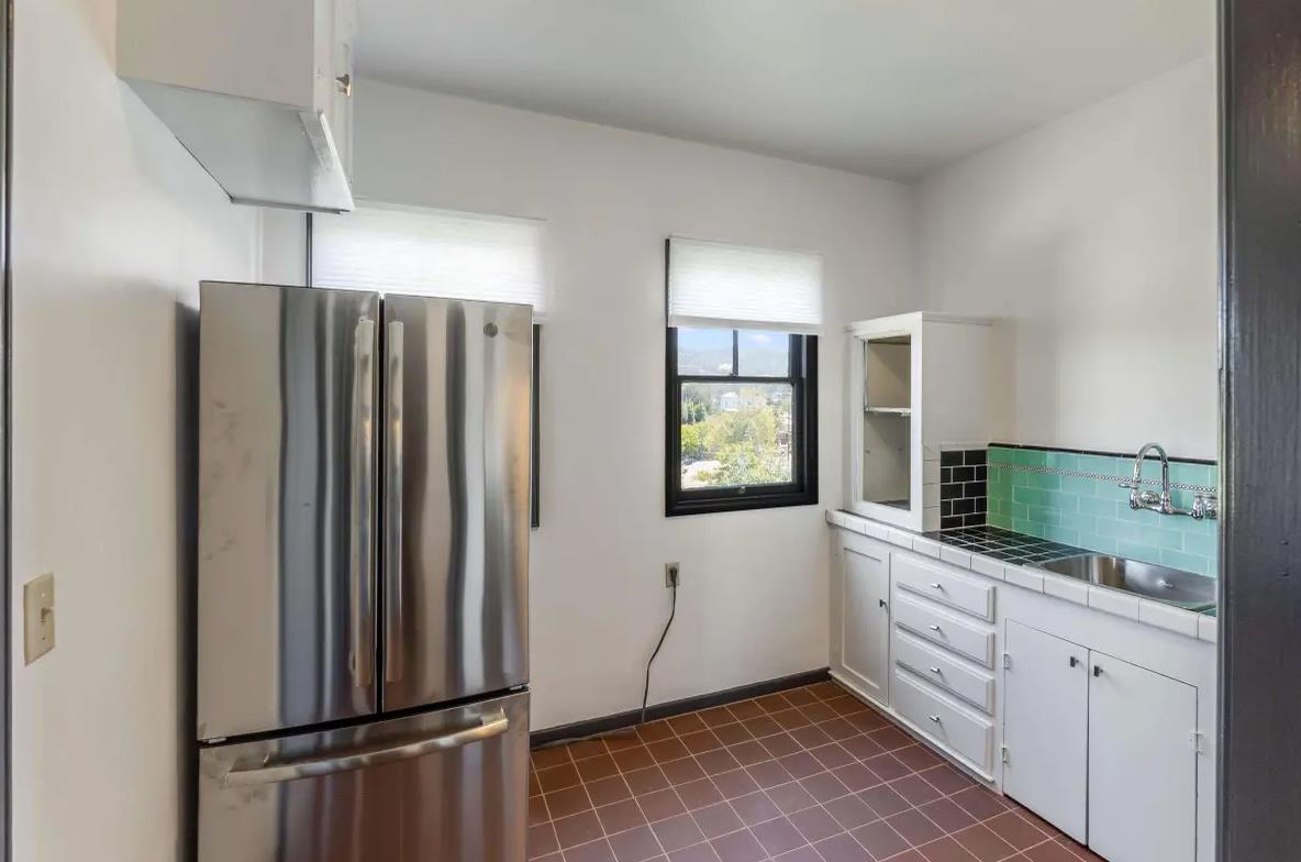 3719 Emerson Street Oakland, CA 94610 - Photo 12 of 34 a kitchen with stainless steel appliances granite countertop a refrigerator and a sink