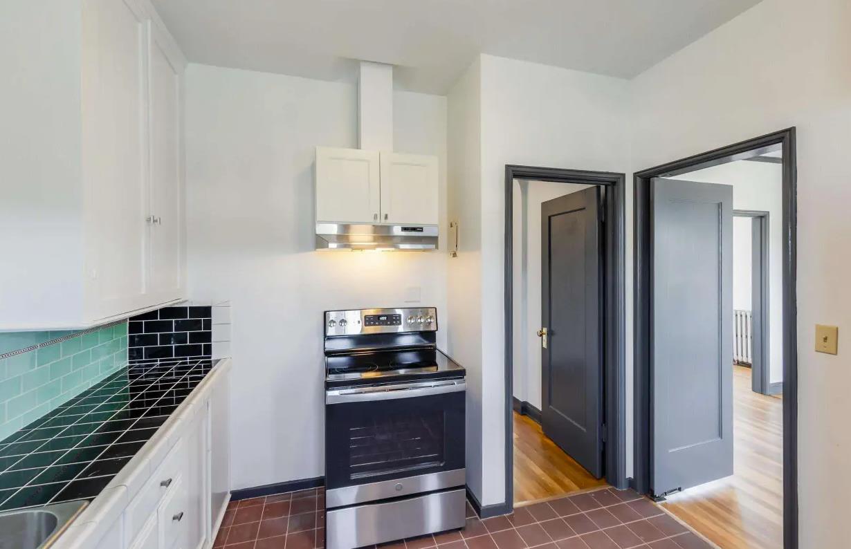 3719 Emerson Street Oakland, CA 94610 - Photo 14 of 34 a kitchen with wooden floor and a stove top oven
