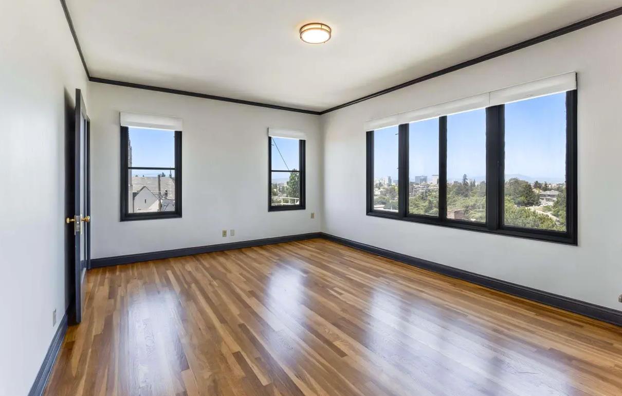 3719 Emerson Street Oakland, CA 94610 - Photo 16 of 34 a view of an empty room with window and wooden floor