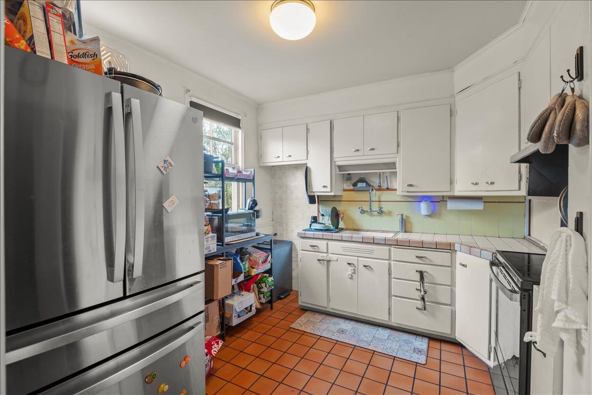 3719 Emerson Street Oakland, CA 94610 - Photo 19 of 34 a kitchen with stainless steel appliances a refrigerator sink and cabinets
