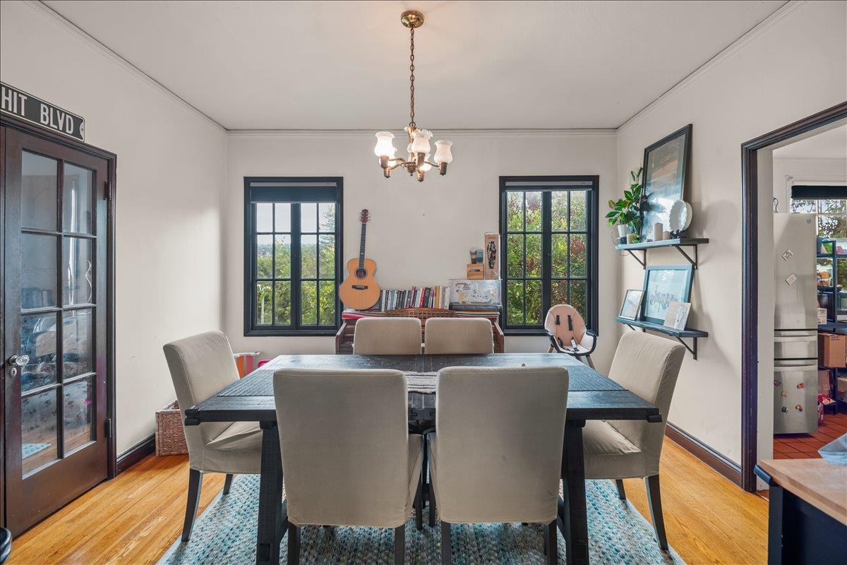 3719 Emerson Street Oakland, CA 94610 - Photo 21 of 34 a view of a dining room with furniture window and wooden floor