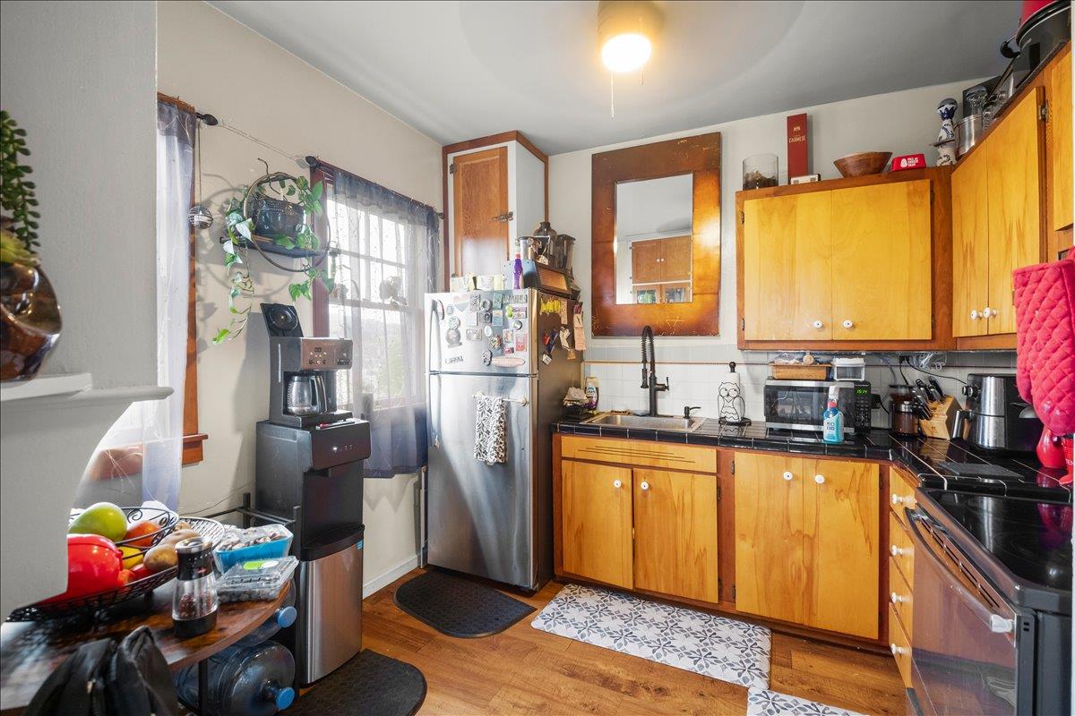 3719 Emerson Street Oakland, CA 94610 - Photo 28 of 34 a kitchen with stainless steel appliances granite countertop a refrigerator and a sink