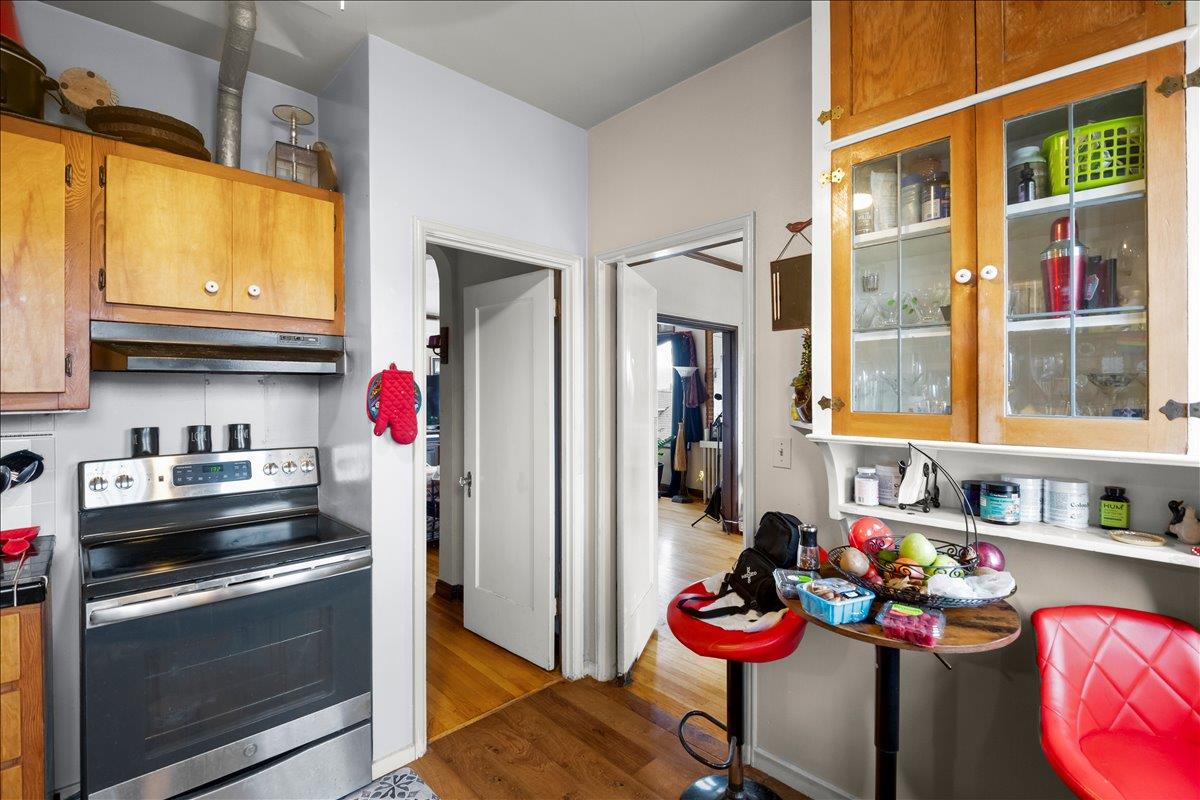 3719 Emerson Street Oakland, CA 94610 - Photo 29 of 34 a kitchen with stainless steel appliances granite countertop a stove and a refrigerator
