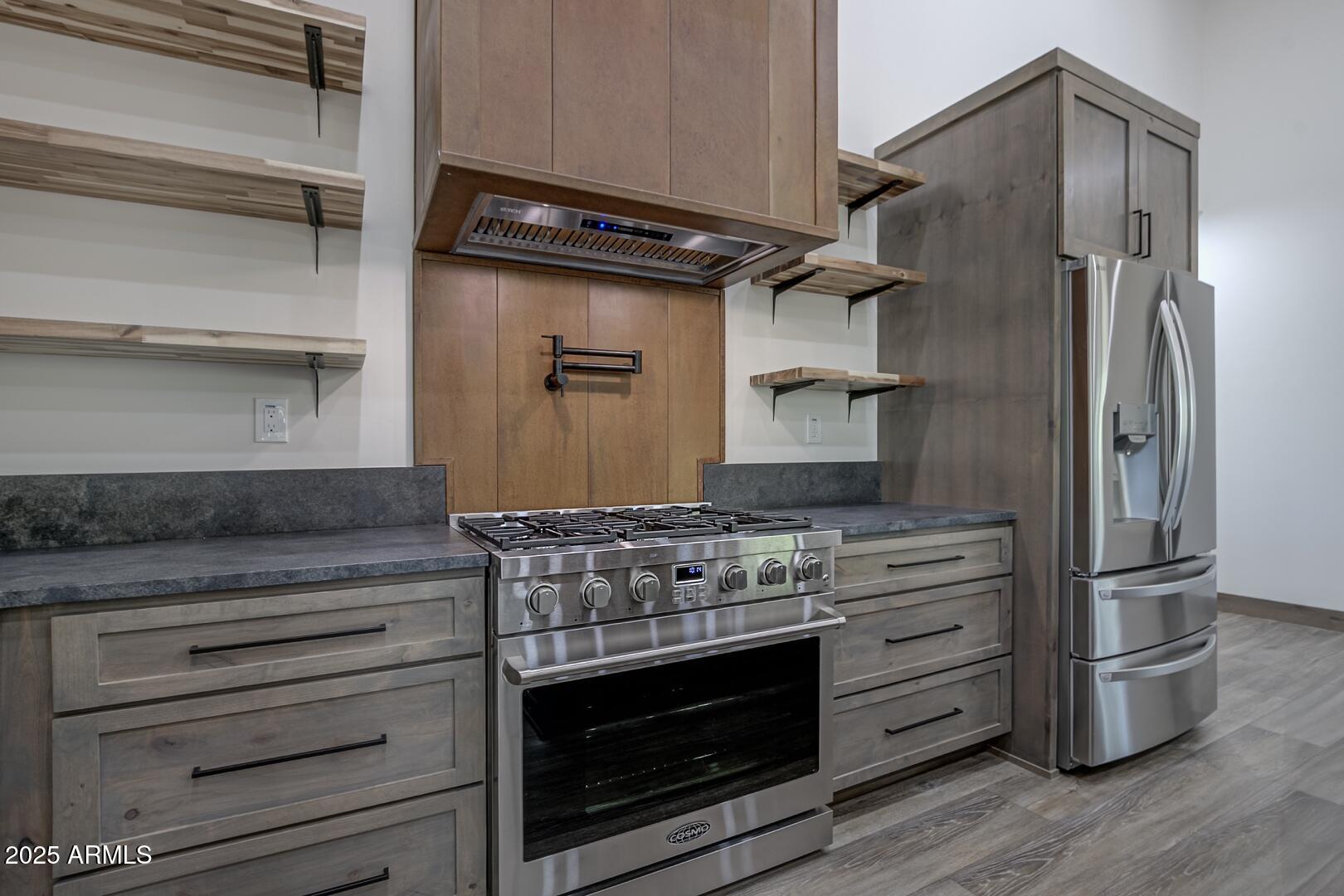 2965 Eagle Ridge Circle Happy Jack, AZ 86024 - Photo 20 of 54 a kitchen with stainless steel appliances granite countertop a stove and a refrigerator