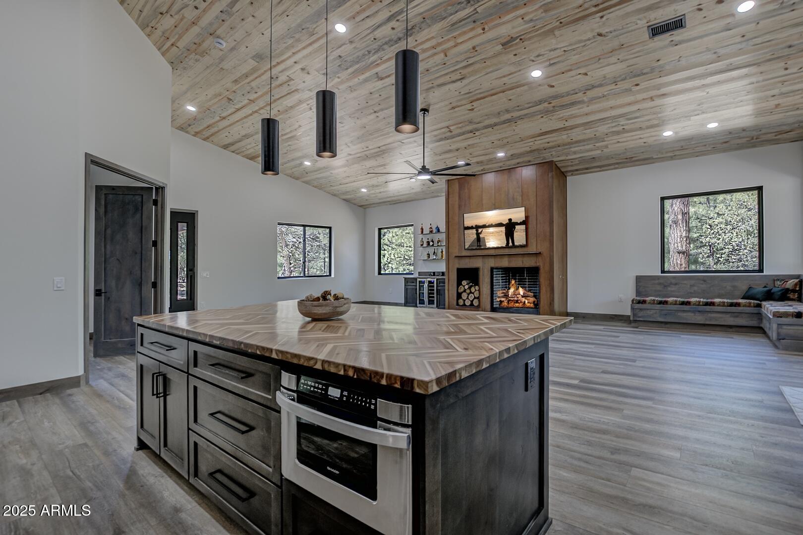 2965 Eagle Ridge Circle Happy Jack, AZ 86024 - Photo 21 of 54 a kitchen with stainless steel appliances granite countertop a stove and a wooden floor