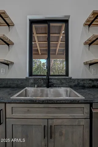 a view of walk in closet with wooden floor
