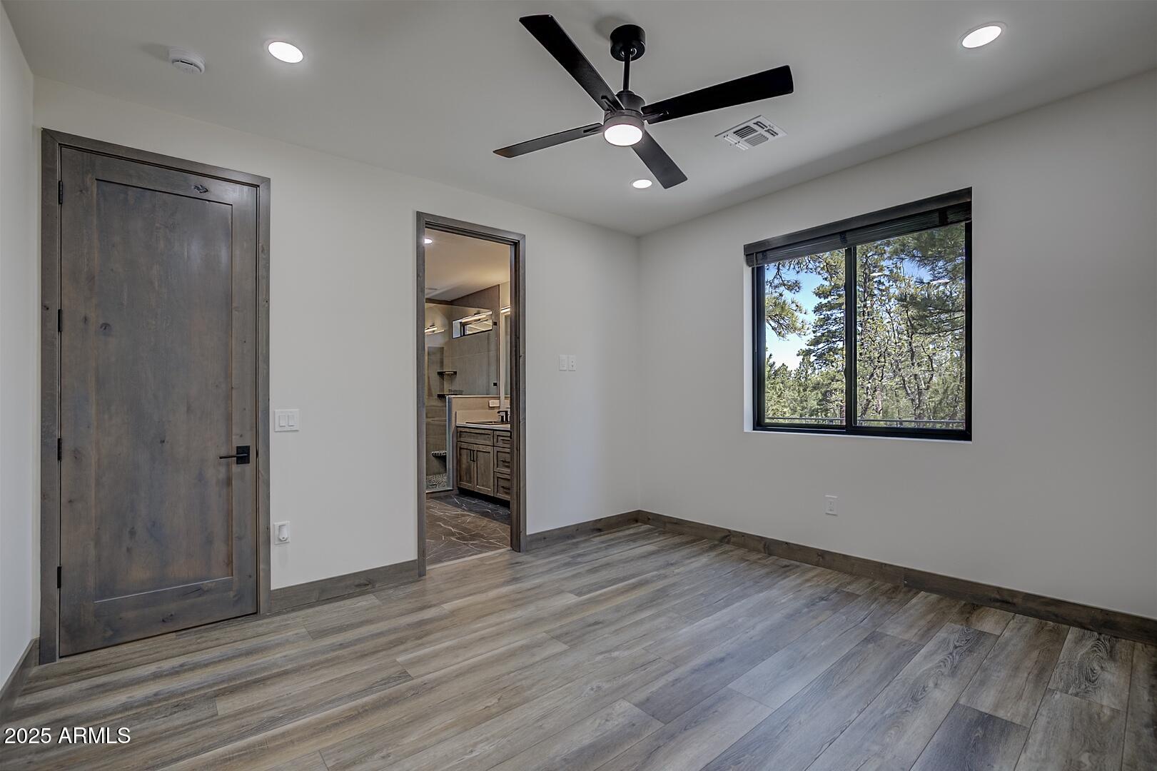 2965 Eagle Ridge Circle Happy Jack, AZ 86024 - Photo 29 of 54 wooden floor in an empty room with a window