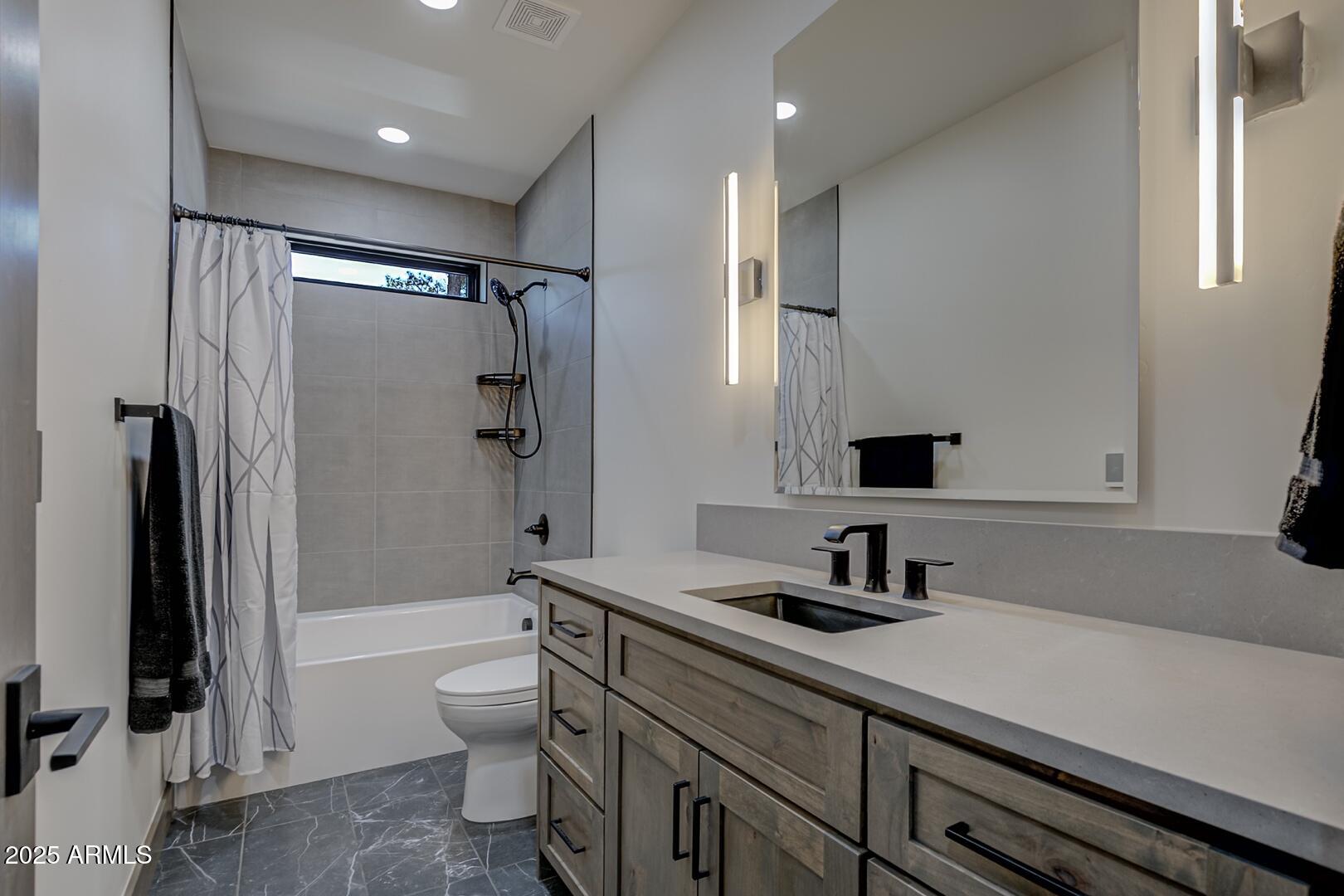 2965 Eagle Ridge Circle Happy Jack, AZ 86024 - Photo 31 of 54 a bathroom with a double vanity sink toilet and shower