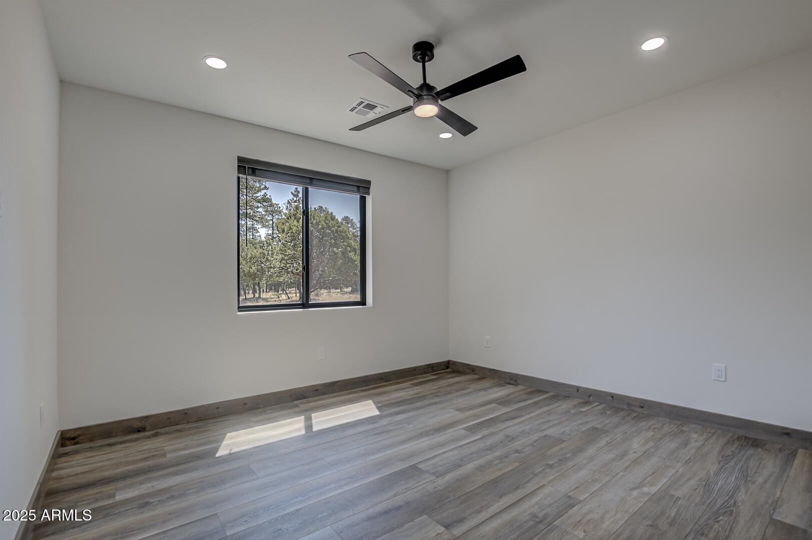 2965 Eagle Ridge Circle Happy Jack, AZ 86024 - Photo 35 of 54 wooden floor in an empty room with a window