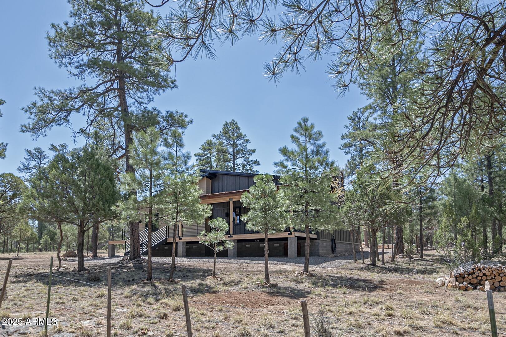 2965 Eagle Ridge Circle Happy Jack, AZ 86024 - Photo 43 of 54 a backyard of a house with lots of green space