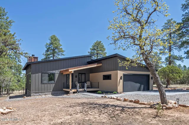 a view of a house with a tree in front of it