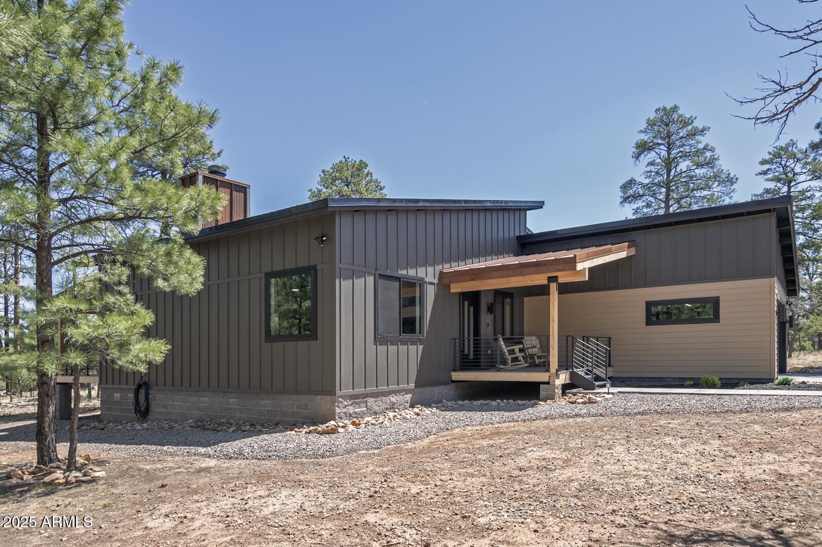 2965 Eagle Ridge Circle Happy Jack, AZ 86024 - Photo 8 of 54 a view of a house with a yard and garage