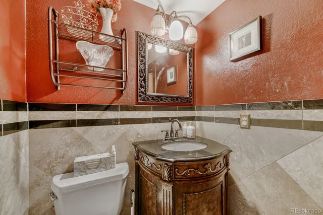 a bathroom with a sink a toilet and mirror
