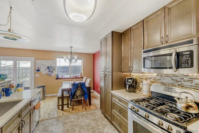 a kitchen with a stove a sink and a microwave