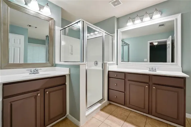 a bathroom with a double vanity sink mirror and double