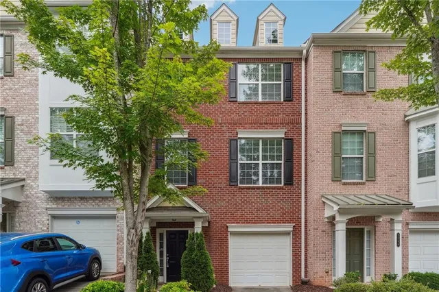 a front view of a house with trees