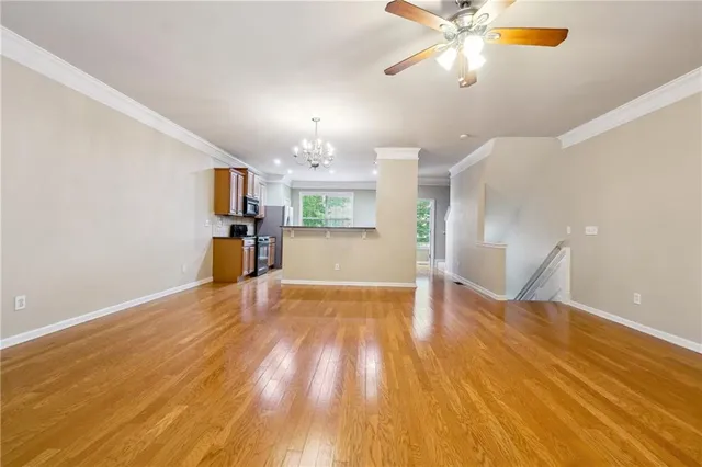 a view of a kitchen a microwave and wooden floor