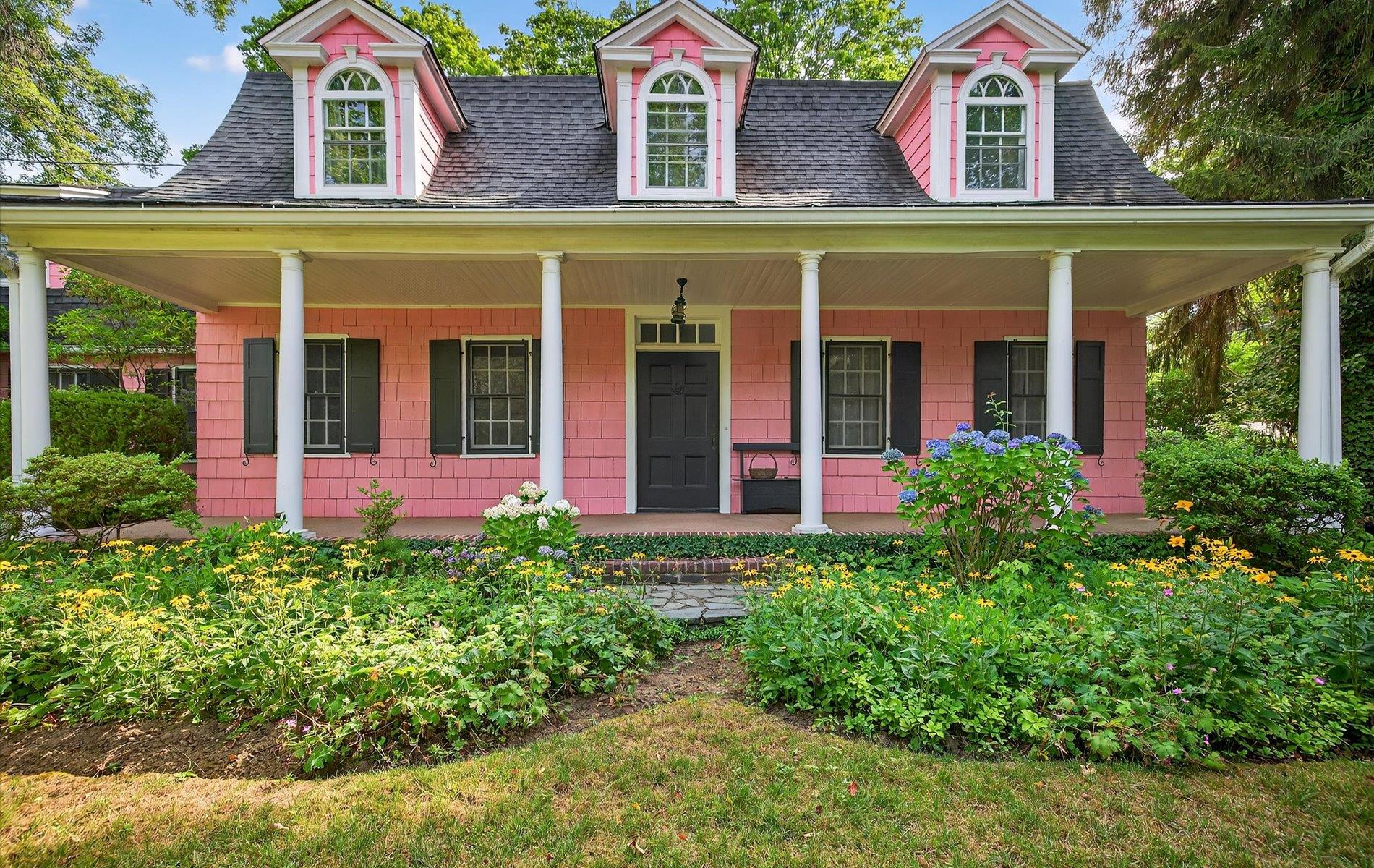 front view of a brick house with a small yard