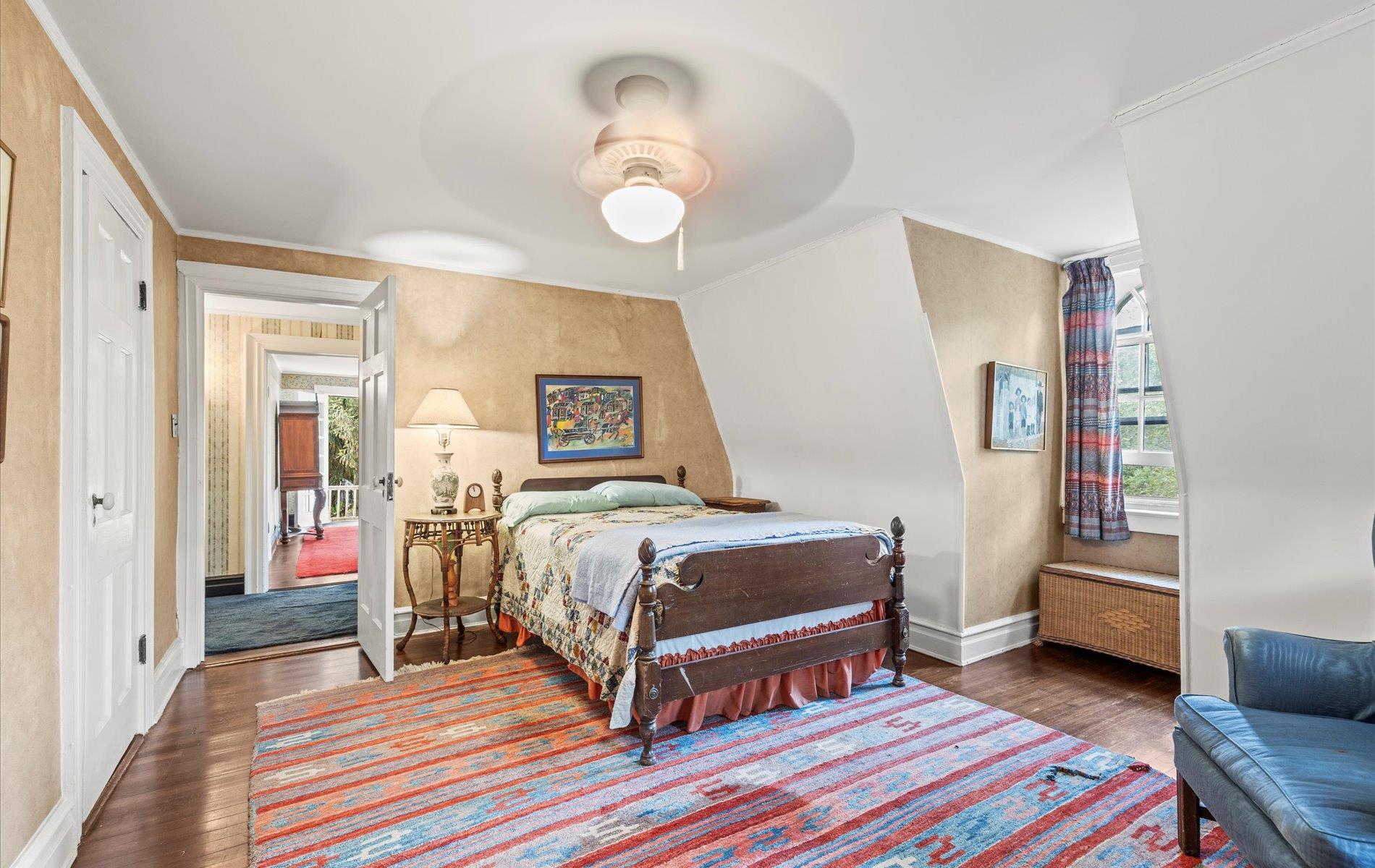 101 Forest Road Queens, NY 11363 - Photo 18 of 50 a bedroom with a bed and a chandelier