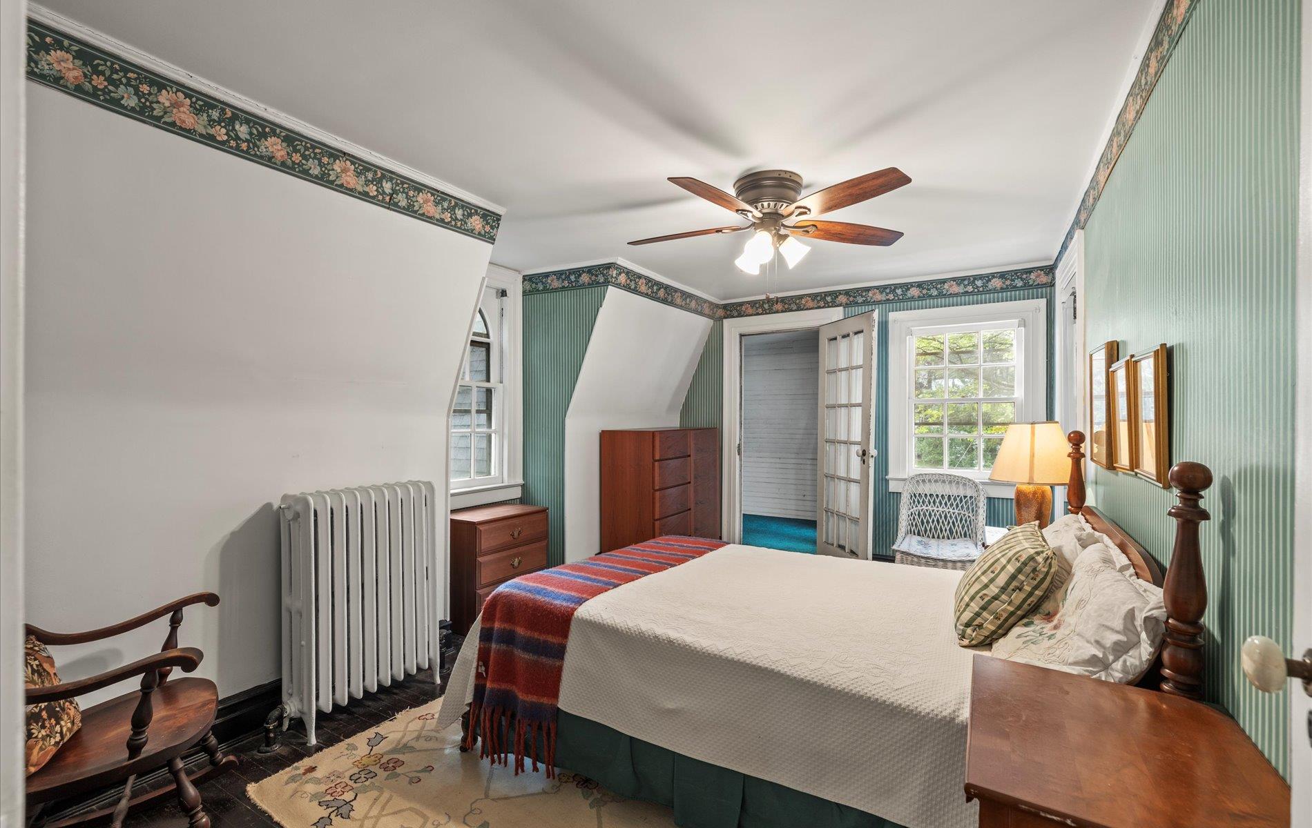 101 Forest Road Queens, NY 11363 - Photo 21 of 50 a bedroom with a bed and a chandelier