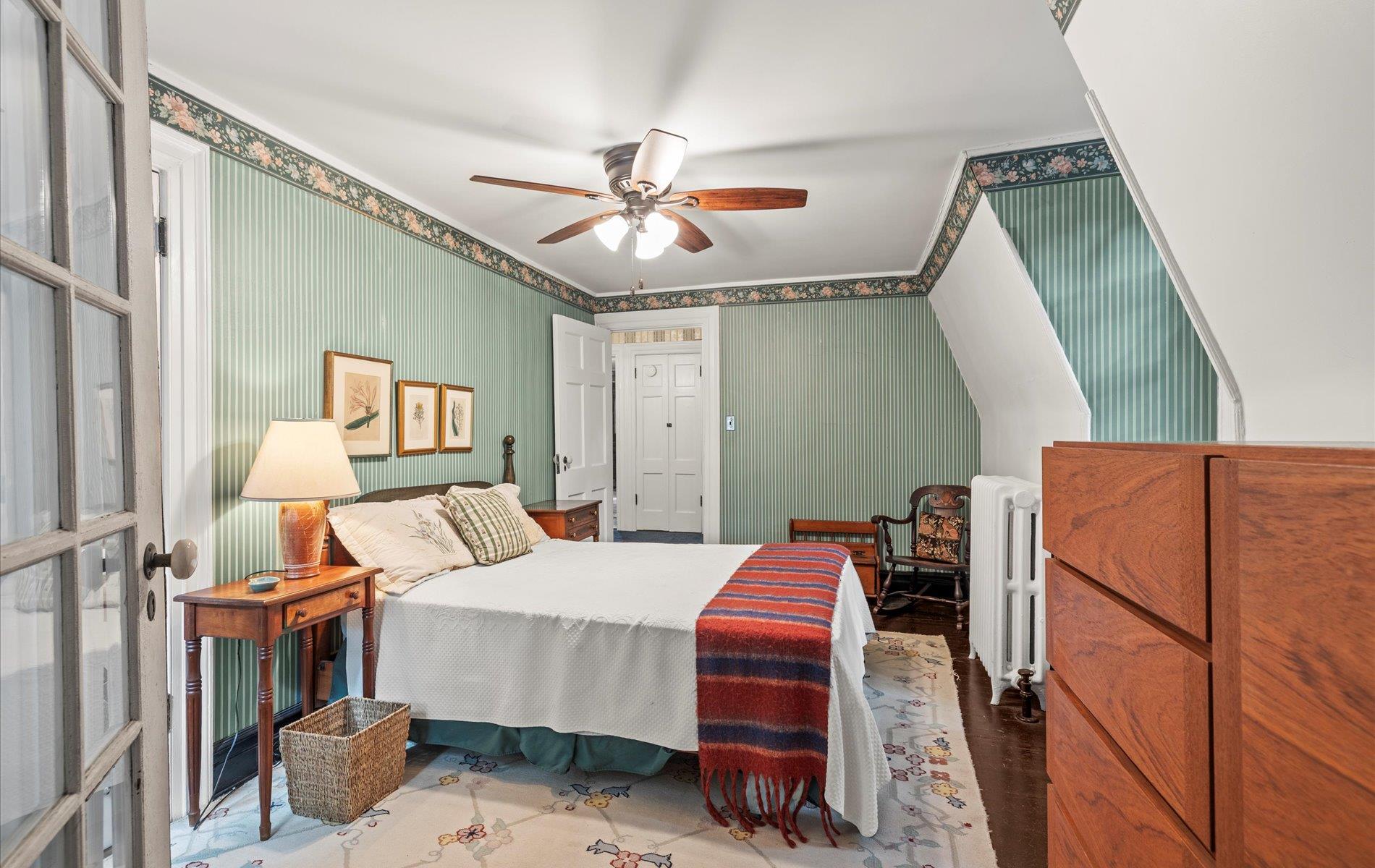 101 Forest Road Queens, NY 11363 - Photo 22 of 50 a bedroom with a bed and a chandelier