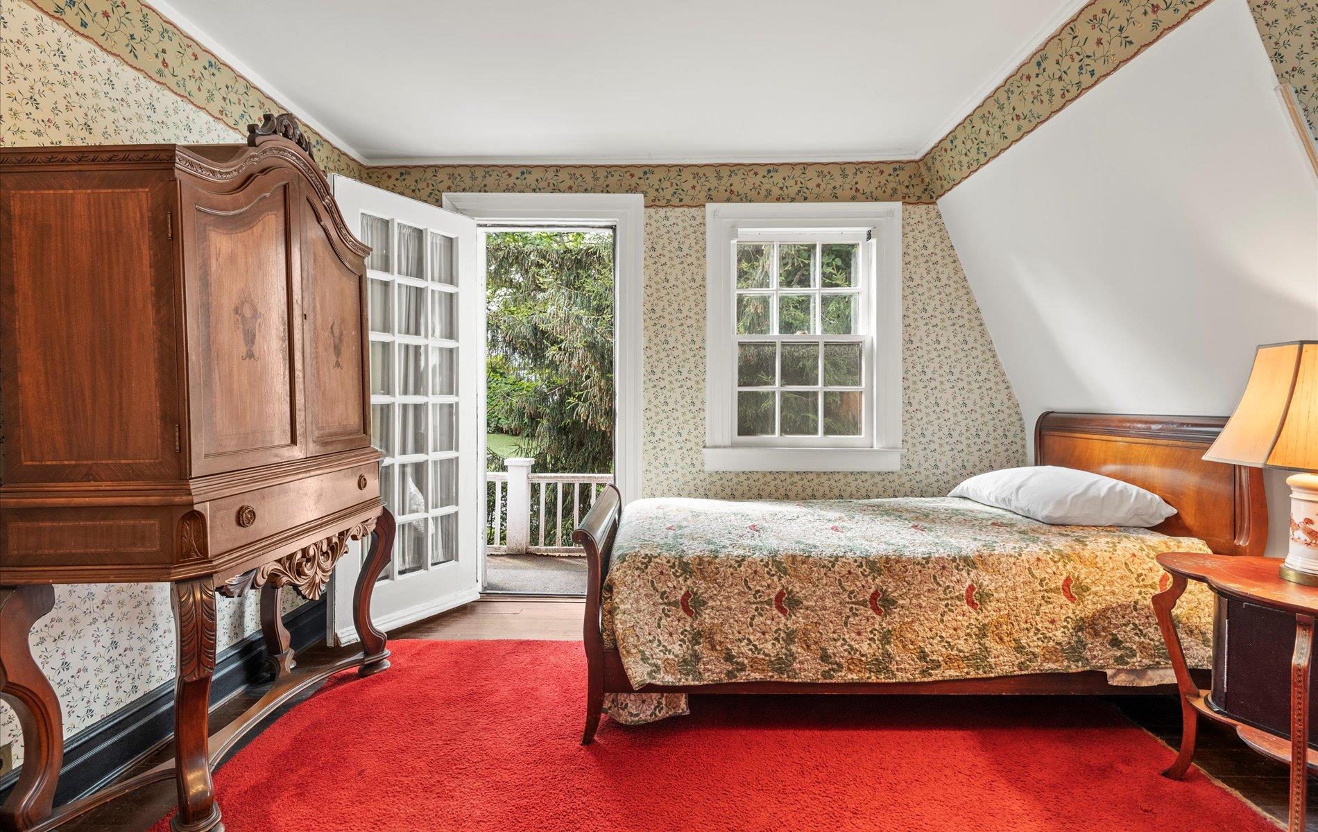 101 Forest Road Queens, NY 11363 - Photo 23 of 50 a bedroom with a bed closet and flat tv screen