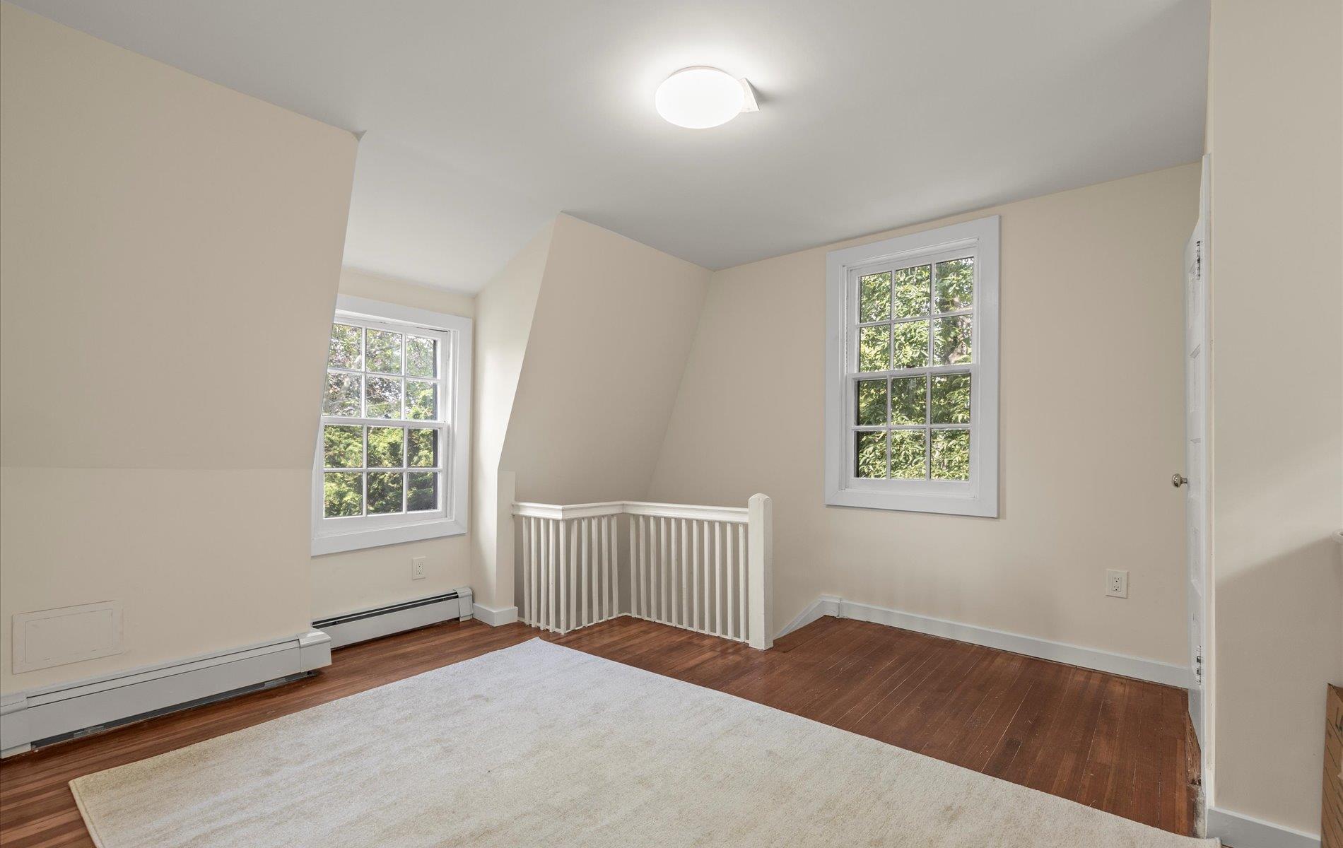 101 Forest Road Queens, NY 11363 - Photo 29 of 50 an empty room with wooden floor and windows