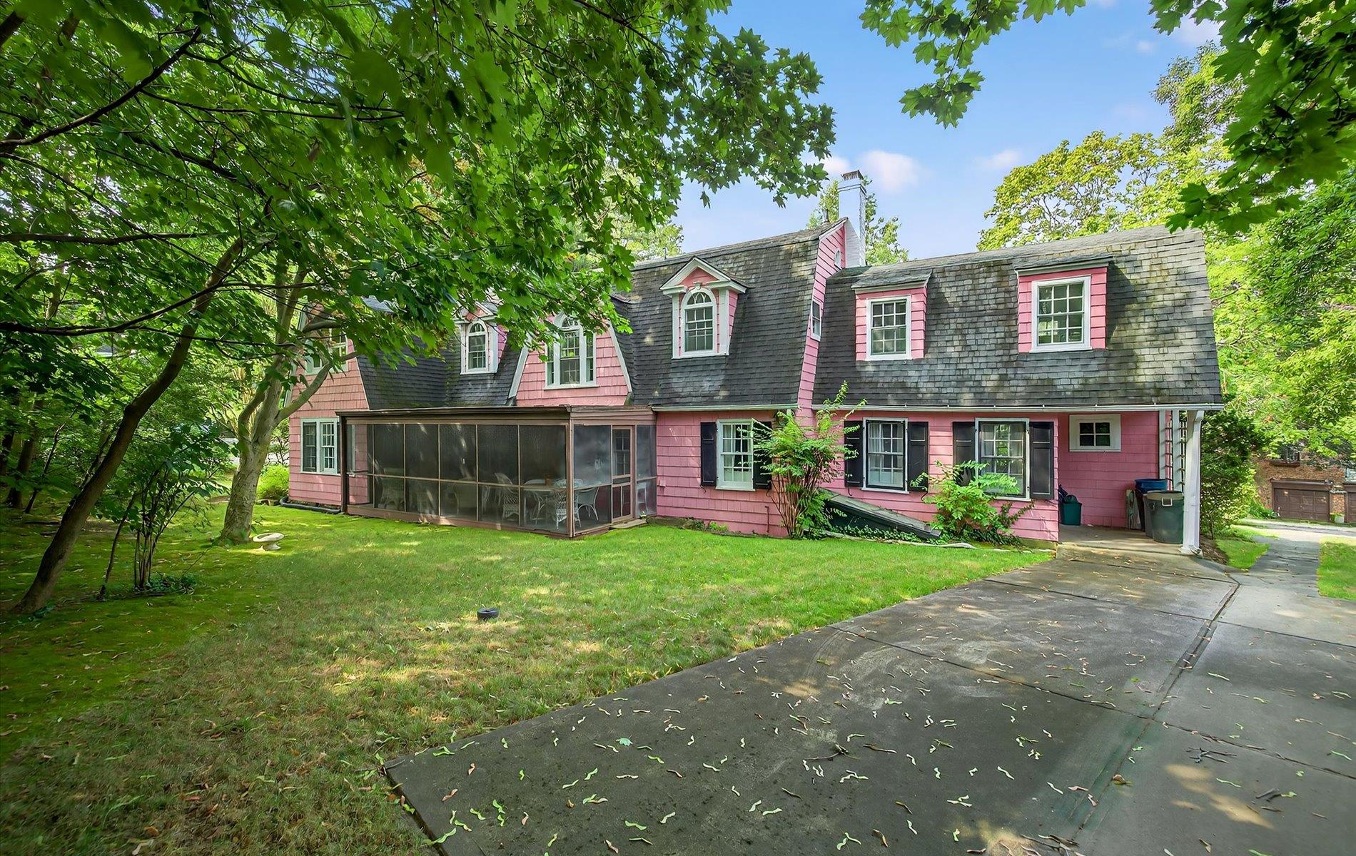 101 Forest Road Queens, NY 11363 - Photo 37 of 50 a front view of a house with a yard and garage