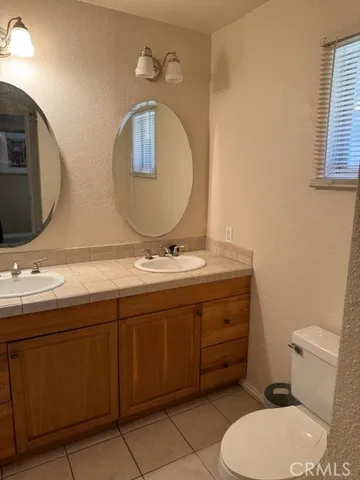 a bathroom with a toilet a sink and mirror
