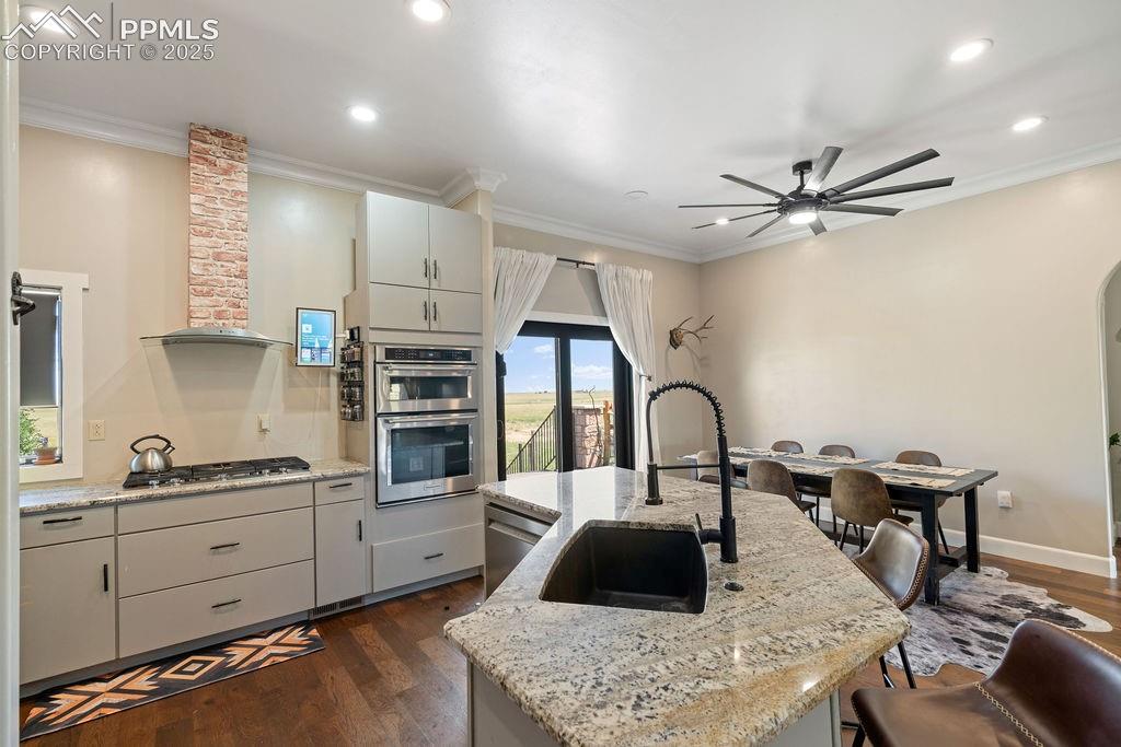 8450 Edison Road Yoder, CO 80864 - Photo 11 of 50 a kitchen with stainless steel appliances granite countertop a sink a stove and a refrigerator