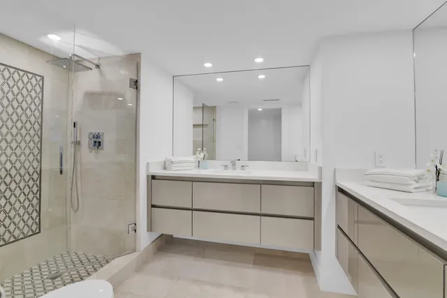 a bathroom with a sink double vanity and shower