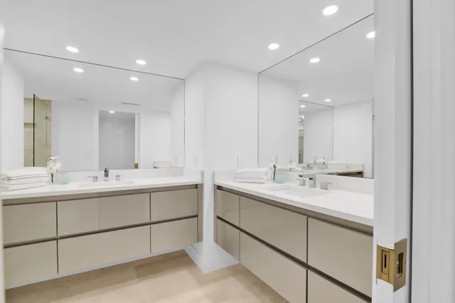 a bathroom with 2 sink and a mirror