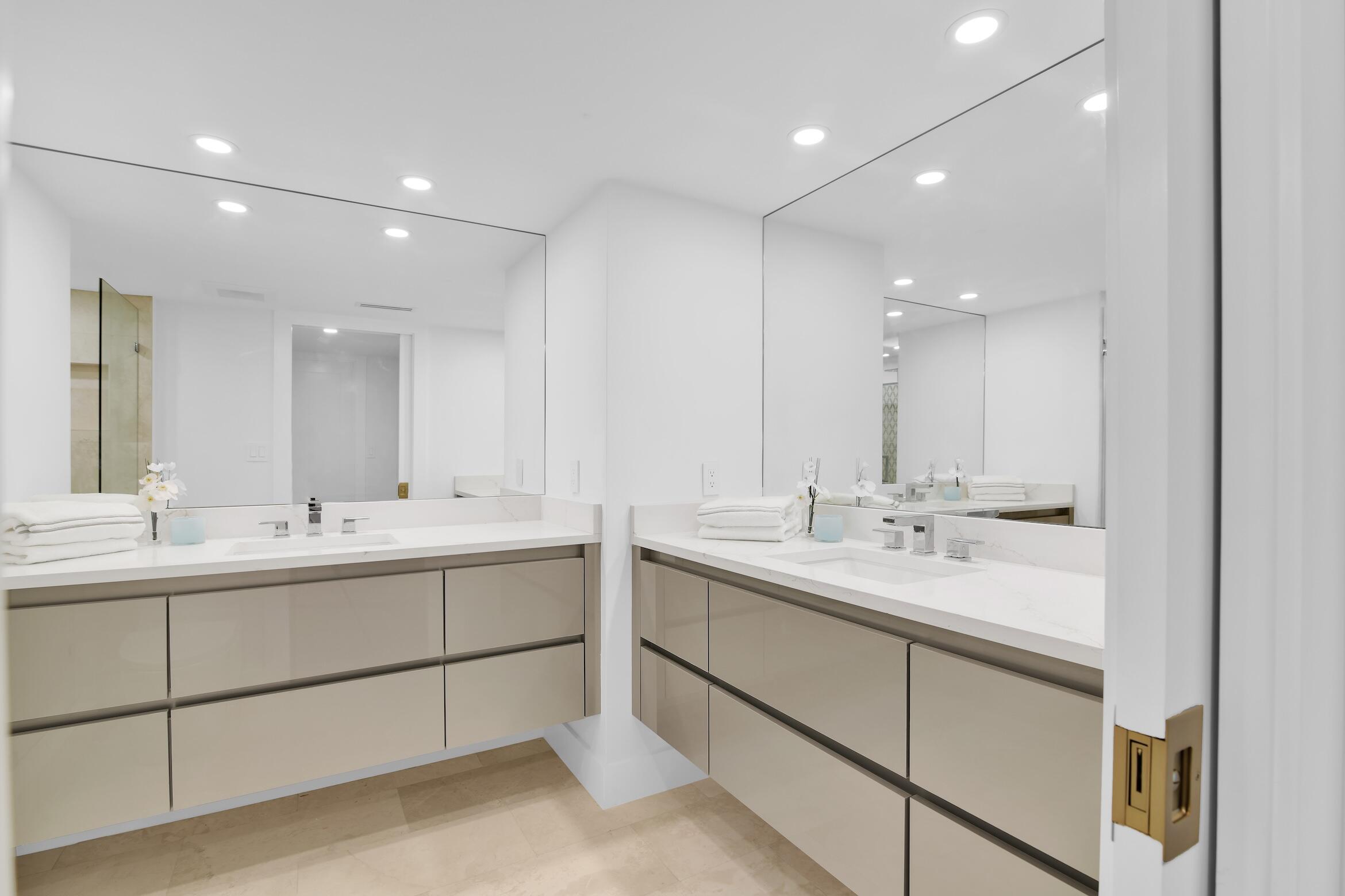 500 South Ocean Boulevard, Unit 303 Boca Raton, FL 33432 - Photo 20 of 46 a bathroom with 2 sink and a mirror