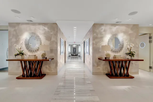 a view of a hallway with furniture