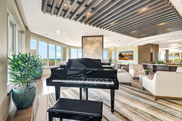 a living room with furniture a window and a potted plant