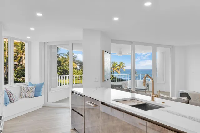 a kitchen with large windows and a sink